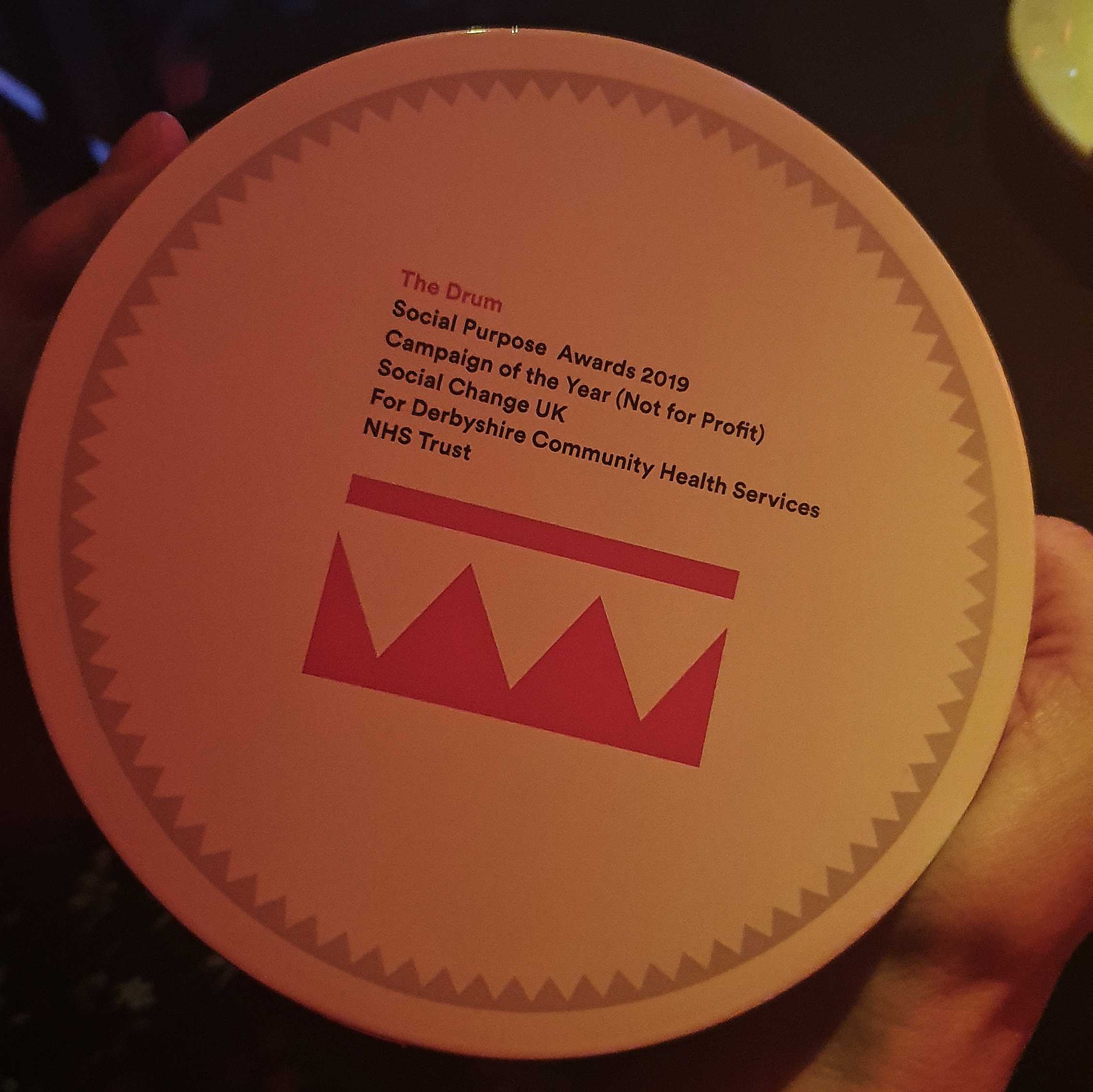 A close-up shot of Social Change UK's Social Purpose award from The Drum.